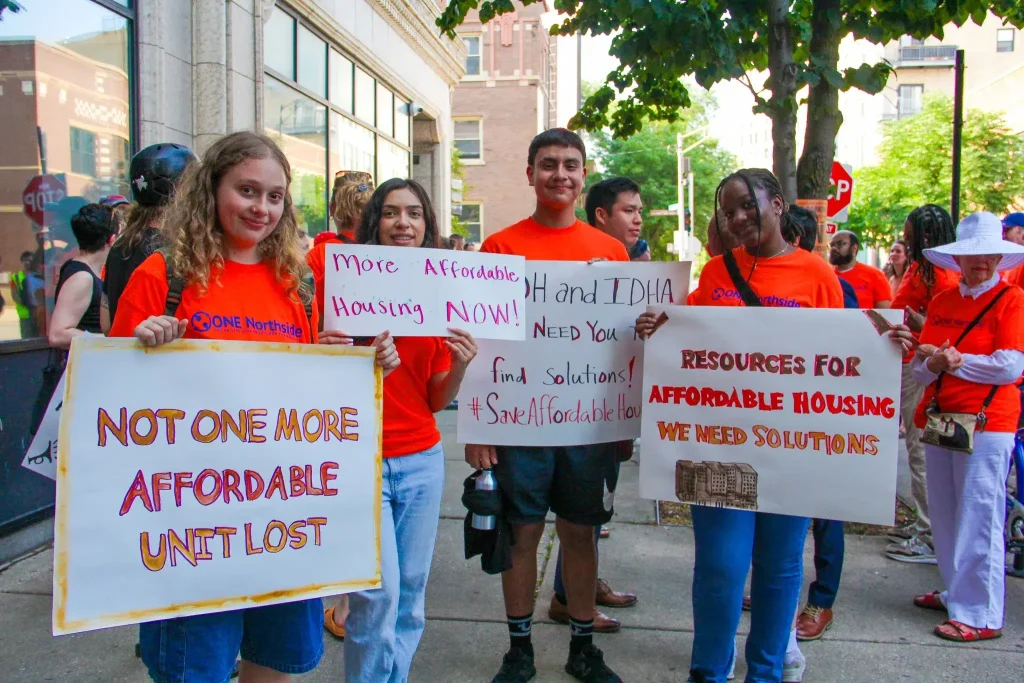 Teens With Housing Signs